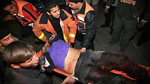 Palestinian medics send a wounded man of the Civil Defense, who was hurt in an Israeli strike, to Shifa hospital in Gaza City, on January 14, 2009. Gaza emergency chief Mo'aweya Hassanein said on Wednesday night that the Israeli army killed on Wednesday 28 Palestinians and wounded 80 others. [Xinhua]