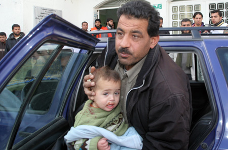 A Palestinian child who was injured in an Israeli army strike is rushed to Kmal Idwan hospital in Jabaliya refugee camp, northern Gaza Strip on January 13, 2009.