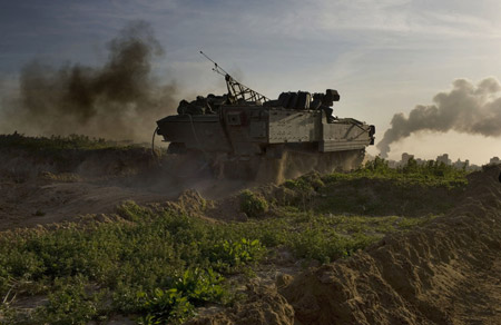 An Israeli armored vehicle moves in the Gaza Strip on January 15, 2009. The Israeli army enlarged ground operations on Thursday into Gaza City as its air and ground military offensives went on for the 20th successive day. [Xinhua]