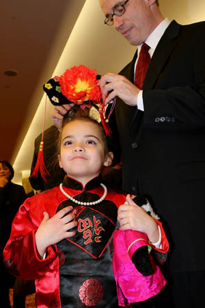 Jacqueline takes part in the Lunar New Year reception in Chinese costume with her father in New York, the United States, on January 14, 2009. Chinese Consulate General in New York and the delegation of China to the United Nations held a reception to celebrate the coming Chinese Lunar New Year. 