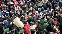 Travelers wait to enter Beijing West Railway Station in Beijing, on January 16, 2009. The passenger flow in 40-day Spring Festival transportation, or Chunyun in Chinese, run up as the Chinese lunar New Year draws near. The Spring Festival, or the Chinese lunar New Year, falls on January 26 this year. [Xinhua]