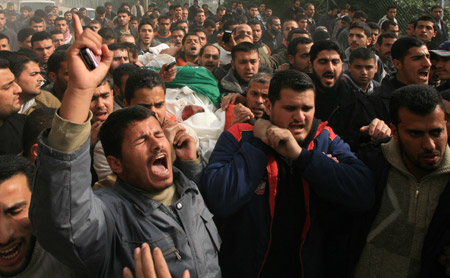 Palestinian Hamas members carry the body of Hamas Interior Minister Said Siam during his funeral in Gaza City, on January 16, 2009. Said Siam was killed on Thursday while hiding in his brother's home in Gaza City.