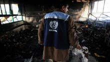 A Palestinian UN worker inspects debris at an UN-run school at Beit Lahya in northern Gaza Strip on January 17, 2009. At least four Palestinians were killed during an Israeli strike on the UN-run school on Saturday morning, where civilians were sheltering from fighting, local medical sources and witnesses said.