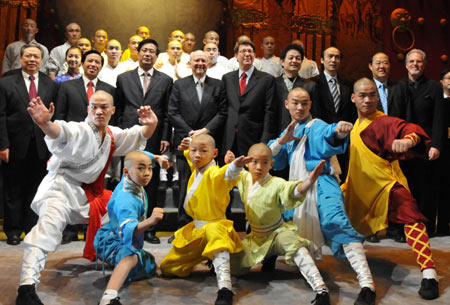 Performers of Chinese Kung Fu show 'Soul of Shaolin' pose with guests after their debut at Broadway's Marquis Theater in New York on January 15, 2009. The 'Soul of Shaolin' was officially opened at Broadway Thursday night, attracting a large audience and prompting local leaders to hail the 'China on Broadway Day.'