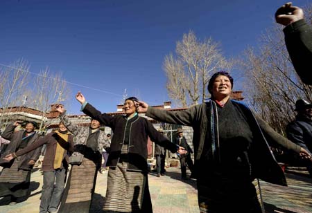 Villagers of the Tibetan ethnic group dance to celebrate the setting of the Serfs Emancipation Day in Banjorihunbo Village of southwest China's Tibet Autonomous Region, on January 19, 2009.