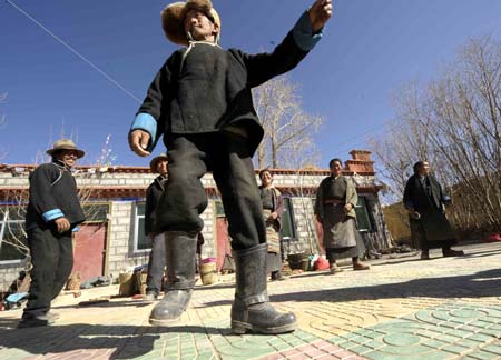 Villagers of the Tibetan ethnic group dance to celebrate the setting of the Serfs Emancipation Day in Banjorihunbo Village of southwest China's Tibet Autonomous Region, on January 19, 2009.