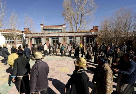 Villagers of the Tibetan ethnic group dance to celebrate the setting of the Serfs Emancipation Day in Banjorihunbo Village of southwest China's Tibet Autonomous Region, on January 19, 2009.