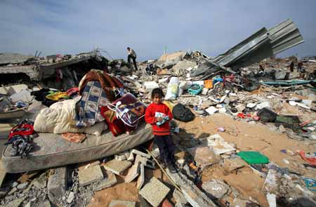 A Palestinian child stands in front of destroyed houses by Israeli strikes in the east of northern Gaza Strip, on January 19, 2009.Right after a ceasefire was declared by both Israel and Gaza militant groups, thousands of Gaza residents went back to their homes they had fled during the war, only to see how huge the destruction was.