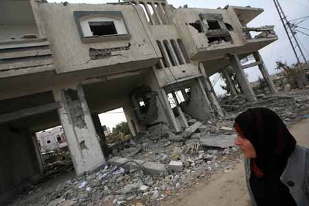 A Palestinian woman looks at the destroyed houses by Israeli strikes in the east of northern Gaza Strip, on January 19, 2009. Right after a ceasefire was declared by both Israel and Gaza militant groups, thousands of Gaza residents went back to their homes they had fled during the war, only to see how huge the destruction was.