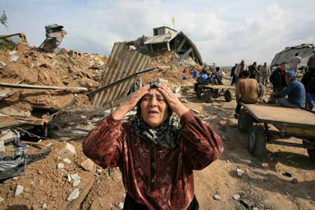 A Palestinian woman cries in front of destroyed houses by Israeli strikes in the east of northern Gaza Strip, on January 19, 2009. Right after a ceasefire was declared by both Israel and Gaza militant groups, thousands of Gaza residents went back to their homes they had fled during the war, only to see how huge the destruction was.