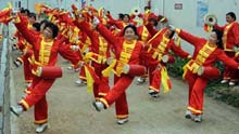 Members of a waist drum team attend a rehearsal for a performance during the upcoming Spring Festival in Wudu Town of Jiangyou City, southwest China's Sichuan Province, on January 20, 2009. Wudu Town is one of the areas hit seriously in the May 12 quake last year, with 2,071 people dead and 16,598 houses destroyed. The Chinese traditional Spring Festival, or lunar New Year, starts from January 26 this year.