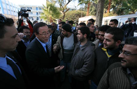 United Nations Secretary-General Ban Ki-moon (L2 Front) talks with people during his visit to the damaged compound in Gaza City, on January 20, 2009. 