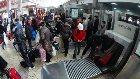 Passengers go through security check at the entrance of the Changsha Railway Station in Changsha, capital of central-south China's Hunan Province, on January 21, 2009. With the approach of the Chinese lunar New Year, Hunan railways have transported over 1 million passengers since the formal start of the annual Spring Festival travel peak on January 11.