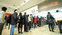 Passengers line up to buy tickets at the Changsha Railway Station in Changsha, capital of central-south China's Hunan Province, on January 21, 2009.