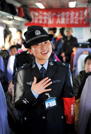 A train steward sings for passengers on the train from Beijing, capital of China, to Yinchuan, capital of northwest China's Ningxia Hui Autonomous Region, on January 20, 2009.