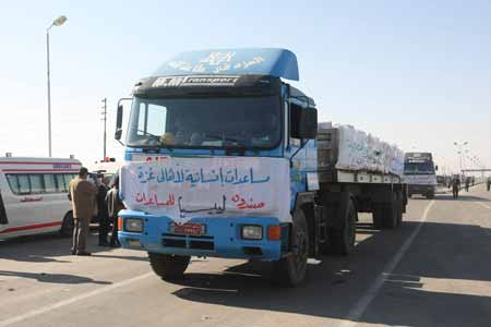 Trucks loaded with humanitarian aids wait outside Rafah Crossing at the Egyptian-Gaza border, on January 21, 2009.