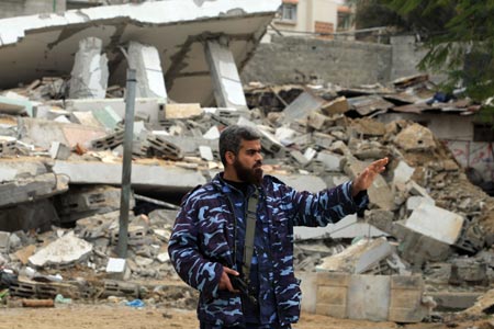 A Hamas policeman is seen at the ruins of al-Zaitoun police station, destroyed in Israeli military strikes, in southeast Gaza City, on January 20, 2009.