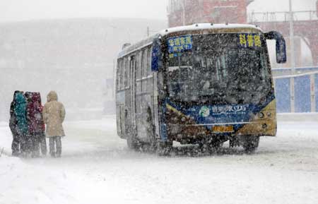 A bus runs against snow in Shenyang, capital of northeast China's Liaoning Province, on January 22, 2009. 