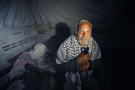 Homeless Palestinian Muhammed Abdu-Rabi sits at his temporary shelter in Gaza, on January 22, 2009. Muhammed lost two daughters and his house in the conflict.