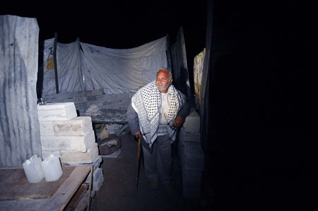 Homeless Palestinian Muhammed Abdu-Rabi stands at his temporary shelter in Gaza, on January 22, 2009. Muhammed lost two daughters and his house in the conflict.