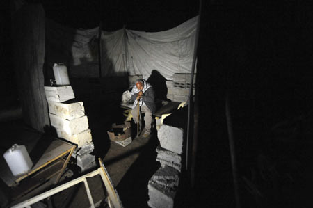 Homeless Palestinian Muhammed Abdu-Rabi sits at his temporary shelter in Gaza, on January 22, 2009. Muhammed lost two daughters and his house in the conflict.