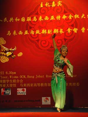 A Chinese student performs folk dance during a Spring Festival evening in Kuala Lumpur, the capital of Malaysia, on January 22, 2009. The festive evening was held by the China Student Federation Malaysia to celebrate the imminent Chinese Lunar New Year.