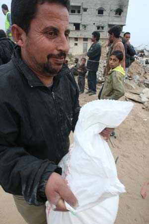 Palestinians receive foods donated by international communities in southern Gaza Strip of Zitton, on January 23, 2009.