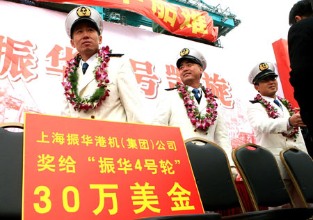 The crew members of the Chinese cargo ship Zhenhua 4 are seen during a commendation ceremony at Changxing Island Port in Shanghai, east China, on January 23, 2009. 