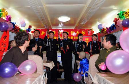 Railway policemen perform for travelers on a train on January 23, 2009. An evening party was held on board to celebrate the upcoming Spring Festival with travelers.