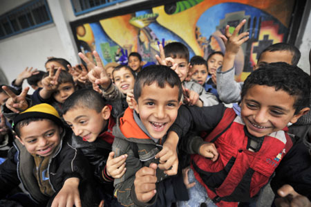 Gaza children pose for photos during their break in the Beit Loliya Boys Elementary School in Gaza City on January 24, 2009. Some 200,000 Gaza children returned to school for the first time since Israel's offensive.