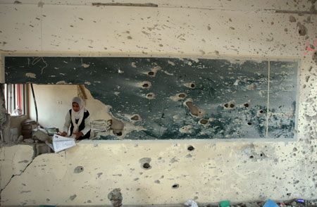 A girl searches for useful books in a destroyed building of Khalil AL-Nubani School in Gaza City on January 24, 2009. Some 200,000 Gaza children returned to school for the first time since Israel&apos;s offensive.