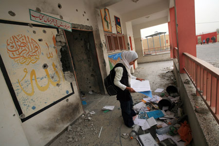 A girl searches for useful books in a destroyed building of Khalil AL-Nubani School in Gaza City on January 24, 2009. Some 200,000 Gaza children returned to school for the first time since Israel&apos;s offensive.