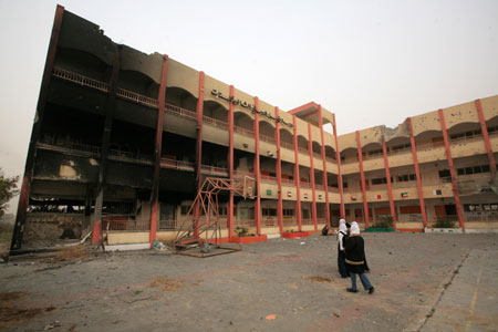 Two Palestinian girls step in front of a destroyed building of Khalil AL-Nubani School in Gaza City on January 24, 2009. Some 200,000 Gaza children returned to school for the first time since Israel&apos;s offensive.