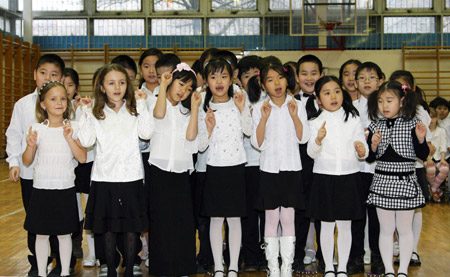 Students of a bilingual school sing a Chinese song at a get-together in Budapest, capital of Hungary, on January 23, 2009.