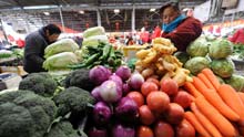 Locals select vegetables for the imminent Spring Festival in Lhasa, capital of southwest China's Tibet Autonomous Region, on January 24, 2009.