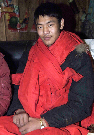 Gou Andong (R), who was transferred from Yingxiu Township by Chinese Premier Wen Jiabao' s special plane after earthquake on May 14, 2008, sits in his family's temporary dwelling in Longxi Village, Longxi Town of Wenchuan County in southwest China's Sichuan Province, January 23, 2009.