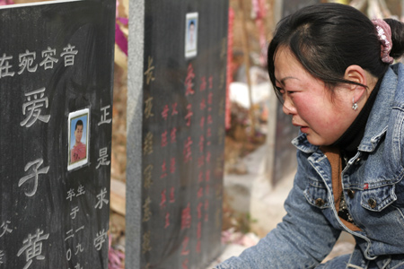 Chen Guifen, a 35-year-old Chinese woman, burns offerings to her deceased son, a victim of the May 12, 2008 earthquake, at a graveyard in Shifang, southwest China's Sichuan Province, on January 24, 2009, ahead of the Chinese Lunar New Year.