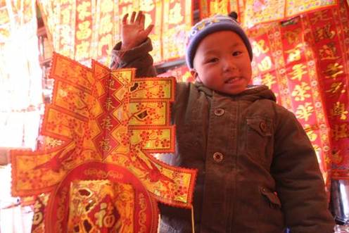 A kid takes a red lanttern to celebrate the Spring Festival in Lhasa, capital of southwest China's Tibet Autonomous Region, on January 25, 2009.