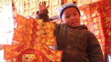 A kid takes a red lanttern to celebrate the Spring Festival in Lhasa, capital of southwest China's Tibet Autonomous Region, on January 25, 2009.