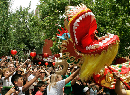 Locals watch the dragon dance during a temple fair held in the China Street in Buenos Aires, capital of Argentina, on January 25, 2009. A Chinese temple fair was held in the China Street on Sunday to celebrate the Chinese Lunar New Year.