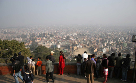 Tourists view Kathmandu, capital of Nepal, from Swyambhu Nath Stupa, a Buddist holy palace and a famous tourist destination in Kathmandu, on January 24, 2009. Nepali government declared to celebrate 2011 as, Visit Nepal 2011, a Tourism Year, with 1 million tourists expected to visit.