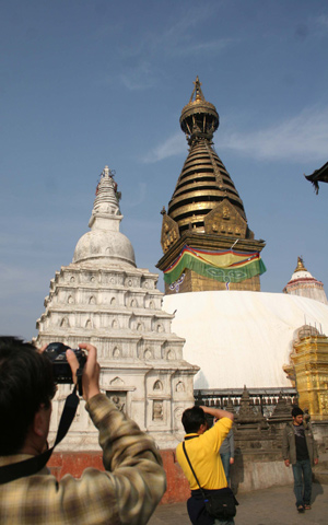 Tourists visit Swyambhu Nath Stupa, a Buddist holy palace and a famous tourist destination in Kathmandu, capital of Nepal, on January 24, 2009.