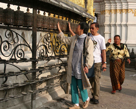 Tourists visit Swyambhu Nath Stupa, a Buddist holy palace and a famous tourist destination in Kathmandu, capital of Nepal, on January 24, 2009.