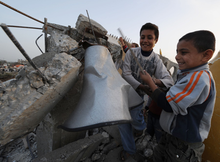 Two Palestinian boys play on the debris of a destroyed mosque in the southern Gaza Strip, on January 26, 2009. [Xinhua]