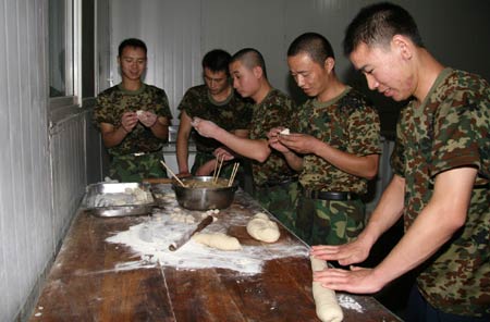 Chinese peacekeeping soldiers make dumplings to celebrate the Chinese Lunar New Year at their base in Monrovia, capital of Liberia, on January 25, 2009. 