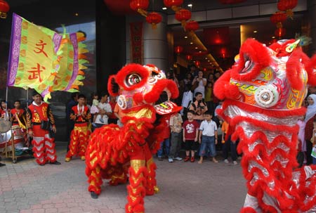 Performers play lion dance in front of the headquarters of Malaysia Chinese Association to celebrate the Chinese Lunar New Year in Kuala Lumpur, capital of Malaysia, on January 26, 2009.