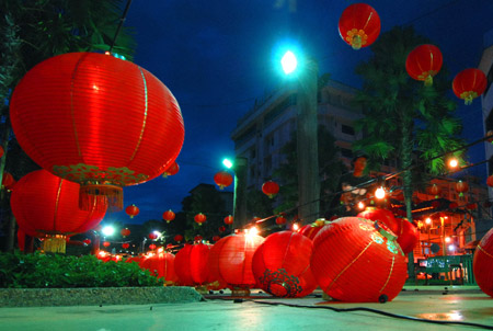 A man prepares to decorate a street with red lanterns in Kota Kinabalu, East Malaysia's Sabah State, on January 23, 2009.