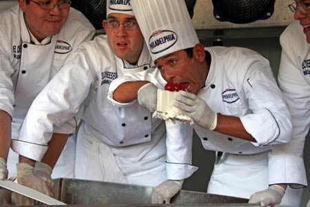 A chef tastes a piece of a giant cheesecake that broke Guinness World Record for the biggest cheesecake of the world in Mexico City, capital of Mexico, on January 25, 2009. The cheese cake, with 2.5 meters in diameter, 55 centimeters in height and 2 tons in weight, was made by 55 chefs and 5 student chefs and cost 800 kilograms of cheese.