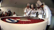 Chefs cut a giant cheesecake that broke Guinness World Record for the biggest cheesecake of the world in Mexico City, capital of Mexico, on January 25, 2009. The cheese cake, with 2.5 meters in diameter, 55 centimeters in height and 2 tons in weight, was made by 55 chefs and 5 student chefs and cost 800 kilograms of cheese.