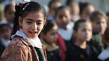 A Palestinian girl attends a group activity at a school in Bayt Lahiya, northern Gaza Strip, on January 27, 2009. Students in Gaza Strip are now receiving psychological treatment by group activities such as narrating, painting, singing and playing games, to foget pains and fears. [Xinhua]